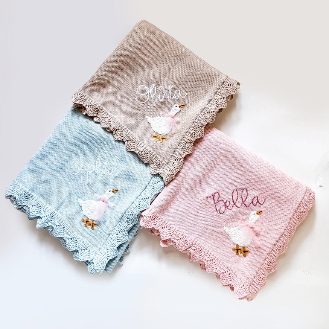 Personalized baby shower gifts including embroidered blankets, monogrammed baby clothes, and custom baby gift sets
