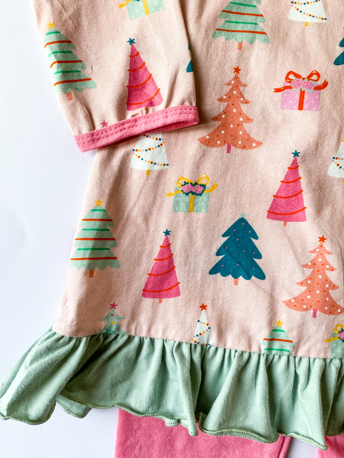 Close-up of festive Christmas print on girls holiday tunic
