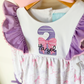 Close-up of embroidered name and age number on bodice