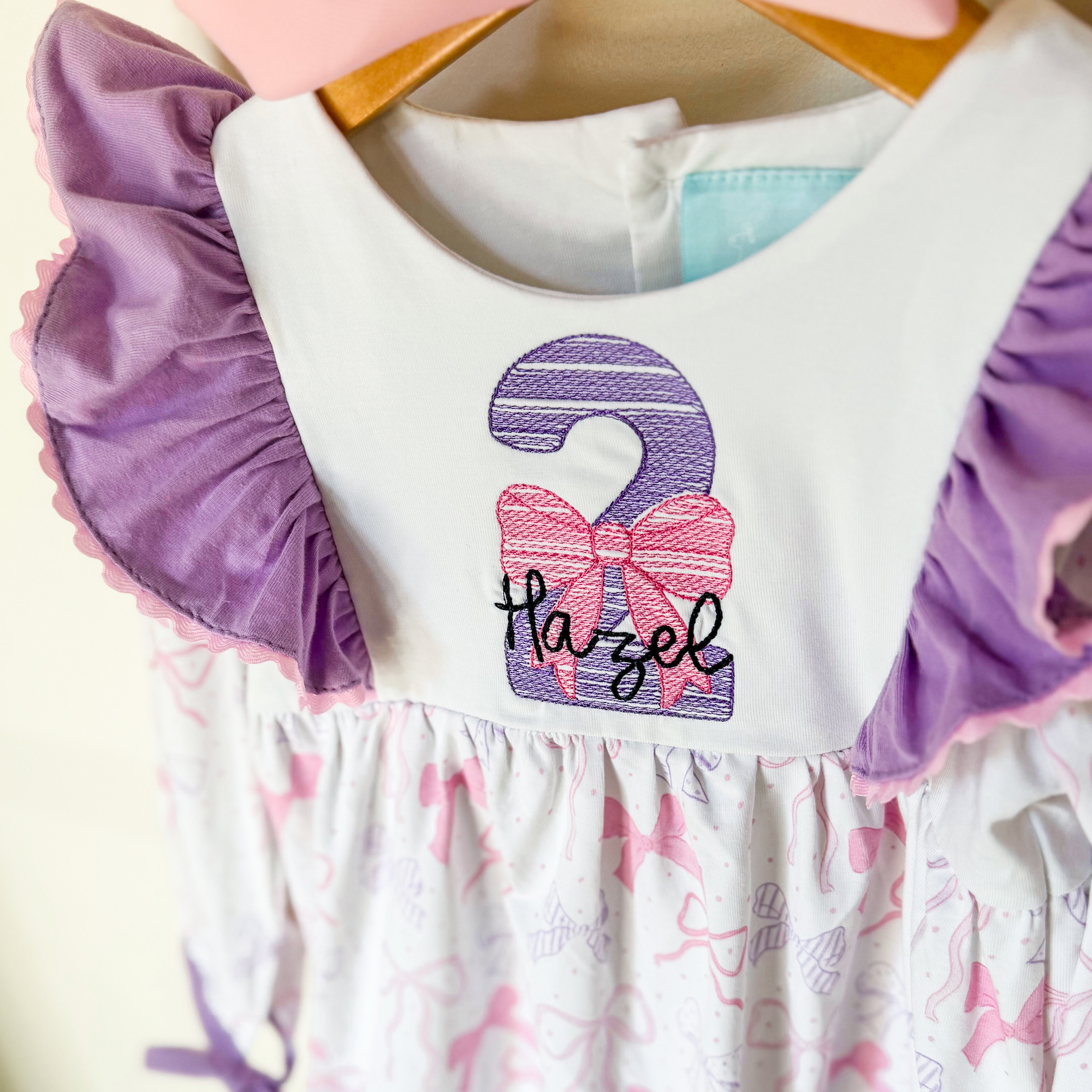 Close-up of embroidered name and age number on bodice