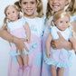 Close-up of girls with dolls in matching dresses